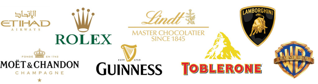 Gold logos including Etihad Airlines, Rolex, Lindt, Lamborghini, Moet & Chandon, Guinness, Toblerone, Warner Brothers